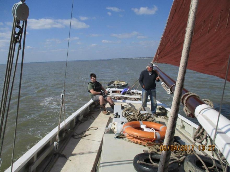 A turn at the helm - young Sea Scout takes the helm of smack Sallie ©Richard Tichener 